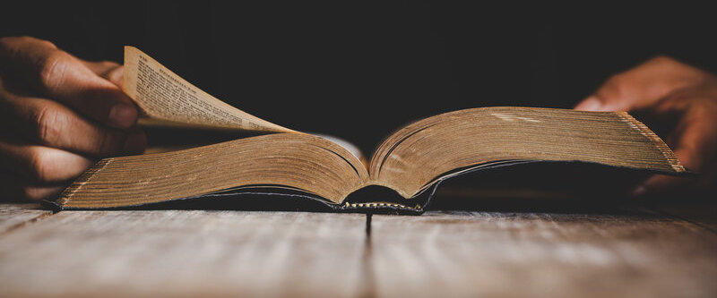 Pastor turning page in bible