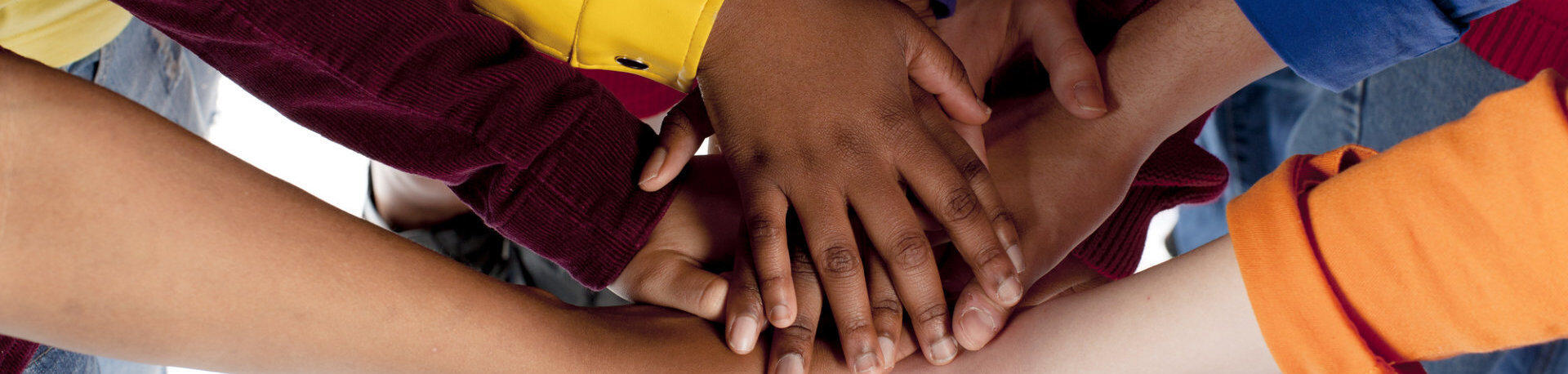 Diverse Teenagers. Putting their hands together.